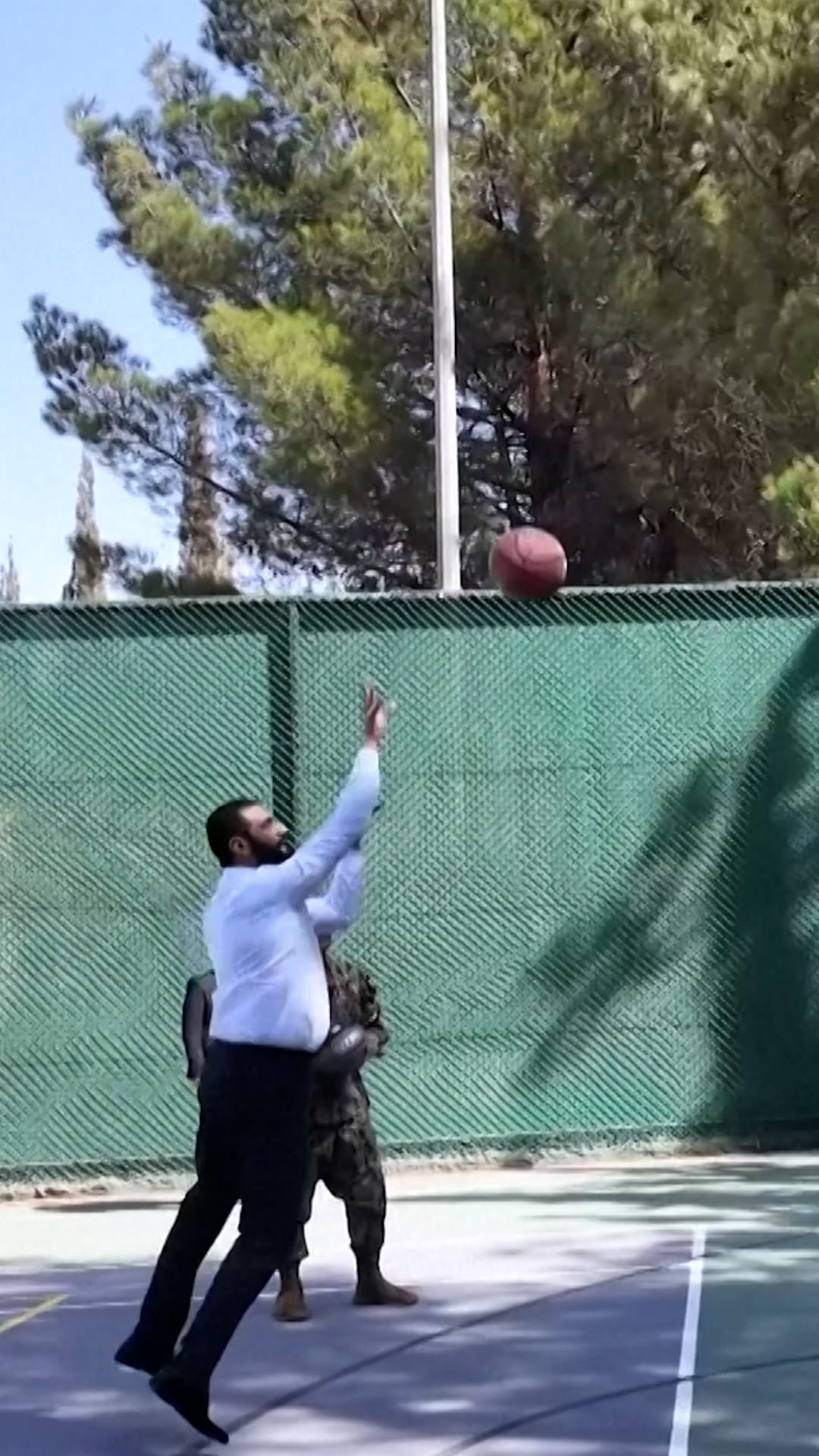 The president of Syria, Ahmed al Shara, plays basketball with U.S. military officers before his meeting with Trump at the White House