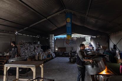 Volunteers in one of the kitchens of the World Central Kitchen (WCK) prepare food to be served to displaced Palestinians in Rafah camp, southern Gaza Strip, 18 March 2024.