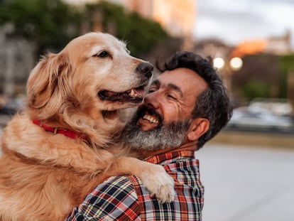 A man holds his dog.