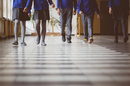 Group of students walking through school hallway