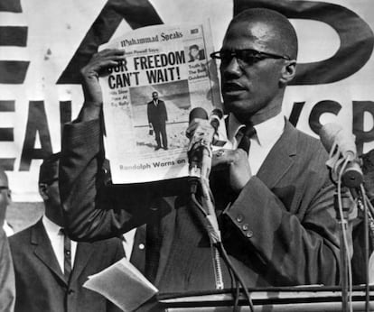 Malcolm X, con un ejemplar del diario 'Muhammad Speaks' durante una concentración en Nueva York en julio de 1963.