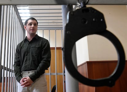 In this file photo taken on March 11, 2020 US ex-marine Trevor Reed, charged with attacking police, stands inside a defendants' cage during a court hearing in Moscow