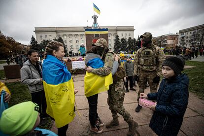 Civilians celebrate with Ukrainian soldiers at Independence Square after the withdrawal of the Russian army from Kherson to the eastern bank of Dnipro River on November 13, 2022. 