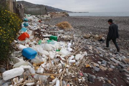 Plastic containers, some previously filled with toxic substances, litter a beach in Granada province.