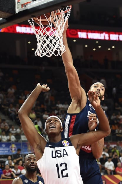 El baloncestista francés Rudy Gobert (a la derecha) encesta ante la mirada de Myles Turner.