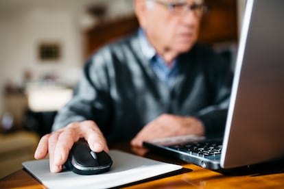 Hand of senior man using mouse, close-up