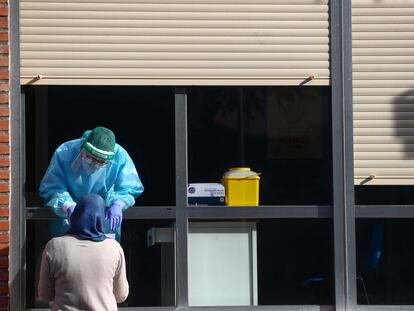 En el centro de salud de Orcasitas entregan el resultado de una prueba del virus a una paciente este miércoles.