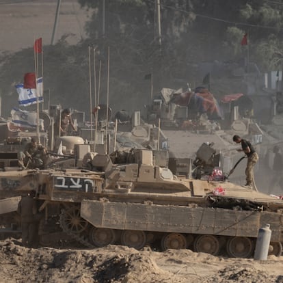 SOUTHERN ISRAEL, ISRAEL - AUGUST 6: Israeli soldiers organize military equipment while standing on armored personnel carriers near the border with the Gaza Strip on August 6, 2025 in Southern Israel, Israel. According to Israeli media reports, senior officials have confirmed Prime Minister Benjamin Netanyahu intends to seek backing from his security cabinet for the "full occupation" of the Gaza Strip, despite dissent within his staff and condemnation by the international community. UN Assistant Secretary General Miroslav Jenca has warned that the plan could endanger the lives of more Palestinians and Israeli hostages held by Hamas. (Photo by Amir Levy/Getty Images)