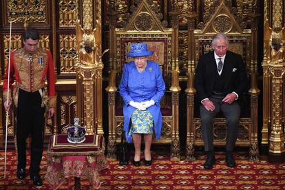 La reina Isabel II permanece sentada junto al príncipe Carlos antes del comienzo de su discurso.