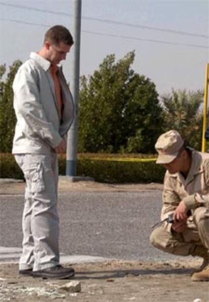 Militares estadounidenses examinan las manchas de sangre en el lugar de los hechos.