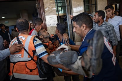 Medical staff and volunteers transport a wounded man to Nasser Hospital on Saturday following the Israeli bombardment of Al Mawasi, west of Khan Yunis.