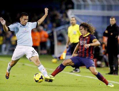 Puyol trata de robarle el balón a Charles.