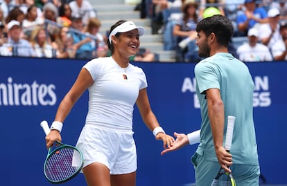 Alcaraz and Raducanu shake hands after an exchange on Center Court at the US Open.