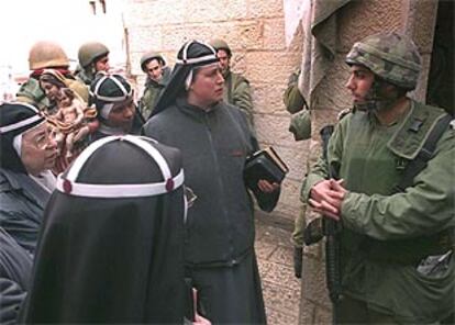 Soldados israelíes y monjas hablan en la sitiada ciudad de Belén, en una foto suministrada por el departamento de Defensa israelí.
