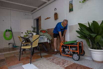 Juan Torres, vecino de la barriada Palmete en Sevilla, muestra su nuevo generador eléctrico alimentado con gasolina.