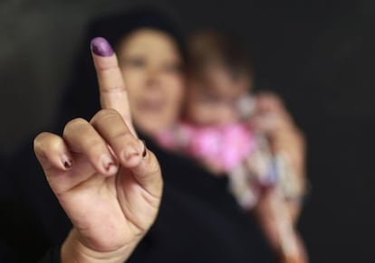 Una mujer con un bebé, tras votar este jueves en El Cairo.