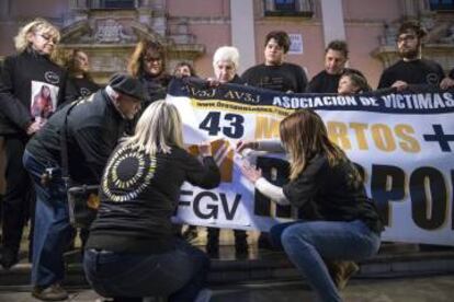 Miembros de la asociación de víctimas del metro tapan el 0 responsables con el logo de FGV, después de que cuatro exdirectivos se declarasen culpables.