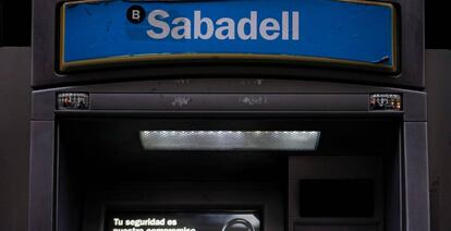 Sabadell bank's logo is seen at an ATM machine outside one of the bank's branches in Madrid