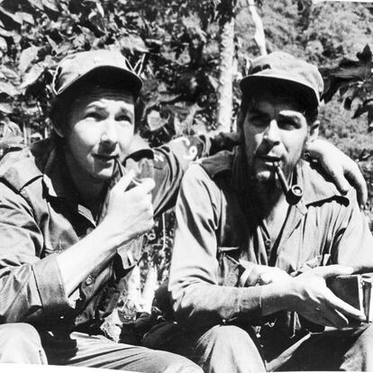 Raul Castro, left, younger brother of Cuban rebel leader Fidel Castro, smokes a pipe with his chief lieutenant, Ernesto Guevara of Argentina shown in their Sierra Cristal mountain stonghold in eastern Cuba, April 1958. (AP Photo/Andrew St. George)