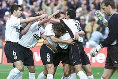 Los jugadores del Valencia abrazan a Baraja tras su gol a la Real Sociedad.