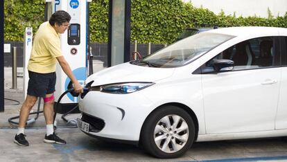 Fernando Pina carga su coche eléctrico en Madrid.