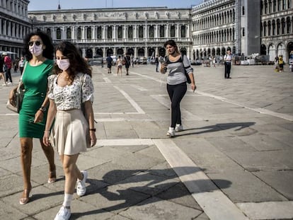 Dos mujeres pasean por la plaza de San Marcos en Venecia (Italia).