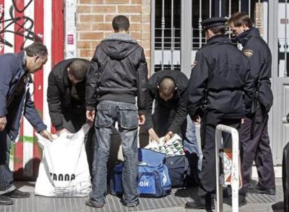 La policía registra en Madrid las bolsas de dos jóvenes sospechosos de haber robado en tiendas.