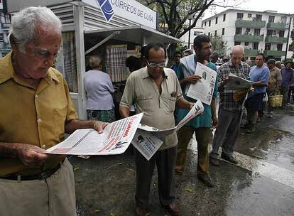 Un grupo de cubanos lee las informaciones sobre el estado de salud de Fidel Castro ayer en La Habana.