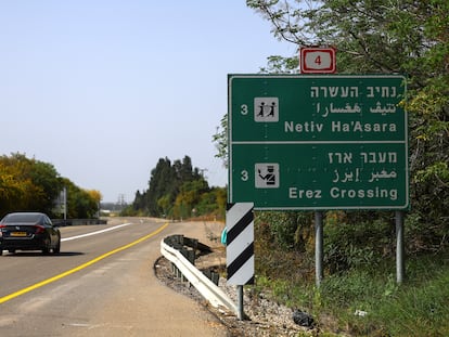 A car passes by an Erez Crossing signboard, after the Israeli cabinet approved the reopening of the crossing into northern Gaza.