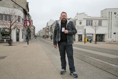 Lorenzo Amblot, 37, homeless man, single, living in Reims, northeastern France, poses with his voting card in Reims on February 20, 2017.
What should be the priorities of the next French president?
"Financial aid should be focused on those who already struggle, instead of wanting to help everybody. There should be a special system to help those on the margins of society  reintegrate, because receiving the Active Solidarity Income (a state payment for the jobless starting at 535 euros a month) is not enough. A special agency dedicated to helping those in need could be created instead. It should also be easier to have access to housing, so that we can rent more easily without having to provide so much paperwork and guarantors." 
 / AFP PHOTO / FRANCOIS NASCIMBENI / RESTRICTED TO EDITORIAL USE - RESTRICTED TO FRENCH ELECTIONS ILLUSTRATION PURPOSE