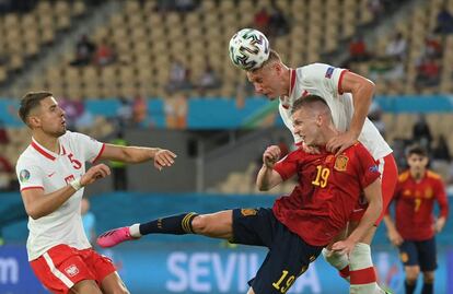 El defensor polaco Kamil Glik compite por el balón con el español Daniel Olmo.