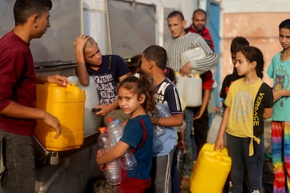 Niños palestinos hacen cola para rellenas lo bidones en Rafah, en el sur de la franja de Gaza.