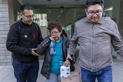 La boliviana Carmen Leigue a la salida de la comisaría, acompañada de su hijo (derecha) y un conocido.