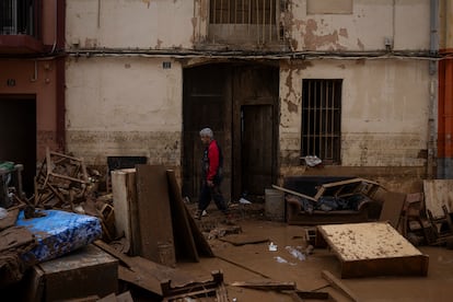 Un hombre camina por una calle que quedó inundada, el jueves en el centro de Aldaia.


