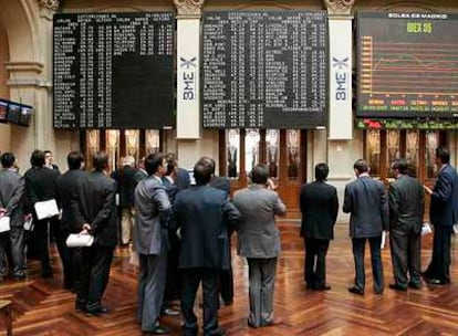 Un grupo de corredores de la Bolsa de Madrid observa la cotización de los valores del Ibex 35.