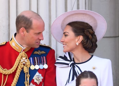 William of England and Kate Middleton on the balcony.  The Princess of Wales's headdress is by Philip Treacy.