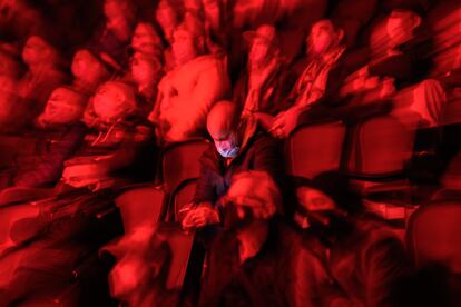 Un espectador con mascarilla consulta su móvil durante un espectáculo deportivo en Suiza en octubre pasado.
