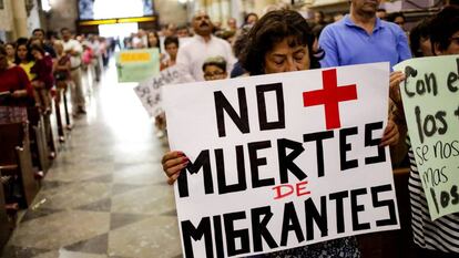 Un mujer carga un letrero durante una misa en honor de un migrante hondureño que fue asesinado por un oficial mexicano. 