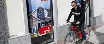 Un joven pasa delante de una sucursal de Mapfre, en Madrid.