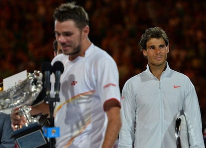 Rafael Nadal looks on as Stan Wawrinka delivers his winner's address.