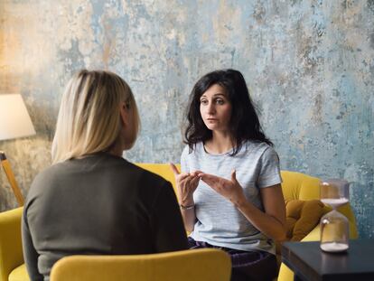 Woman psychologist talking to patient woman. Therapist's gestures. Female talking in coworking office