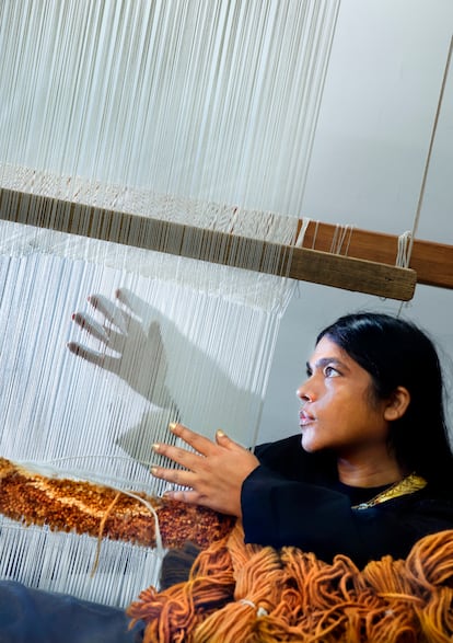 Kavita Parmar poses next to a loom at the Royal Tapestry Factory in Madrid.