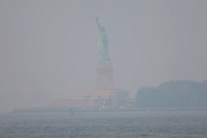 El humo de los incendios forestales canadienses cubren la Estatua de la Libertad, este jueves.