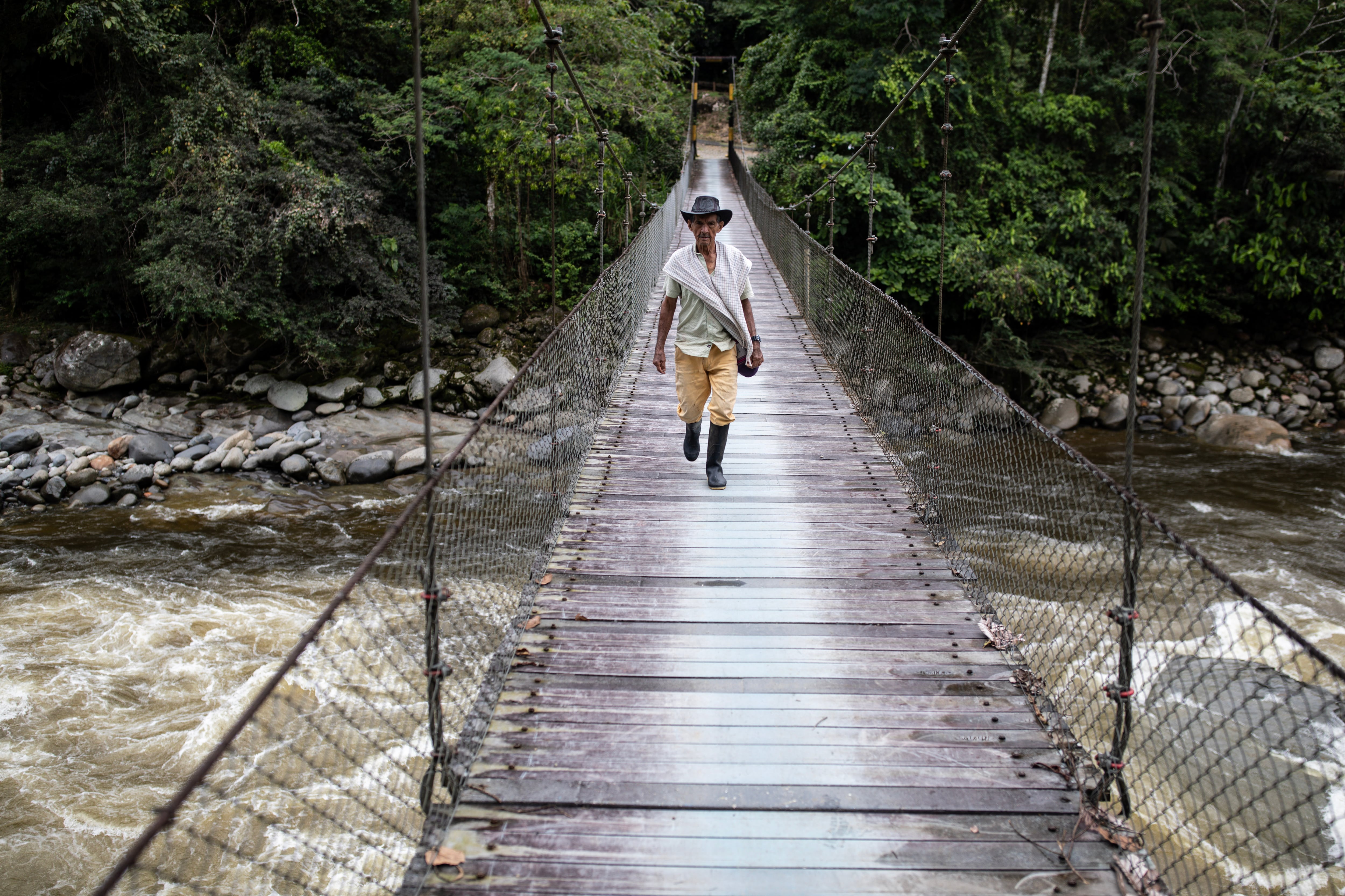 Eladio Barragán cruza el puente del río Guamuez, en Putumayo.