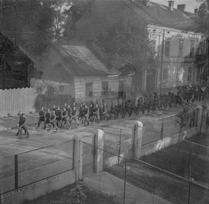 A shot of Jagiełłły Street in which a group of Nazi soldiers are parading. The photograph was taken from the house, number 27, where the Barmeyer family lived.