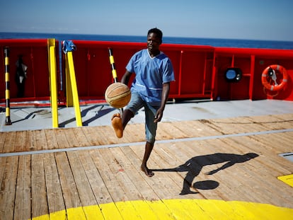A migrant plays ball on his eighth day on board Open Arms Uno rescue boat waiting for the Italian government to give it a port to disembark, off the coast of Sicily, Italy August 24, 2022. REUTERS/Juan Medina