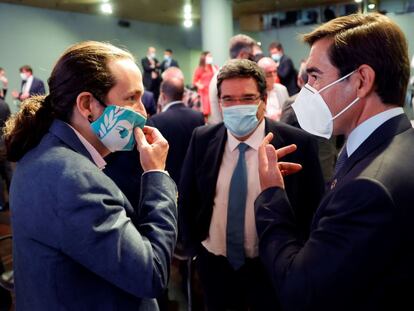 Iglesias conversa con el presidente del BBVA, Carlos Torres, junto con el ministro de Seguridad Social, José María Escrivá,  este lunes en Madrid.