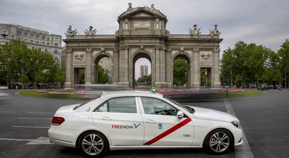 Un taxi con la nueva marca FreeNow pasa por la Puerta de Alcal&aacute;, en Madrid.