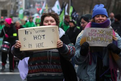 People hold placards during the annual Big Climate March 2023, in Brussels, Belgium, December 3, 2023.