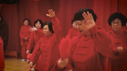 A group of Chinese seniors practices a traditional dance in the cultural center of Chinese New Year.